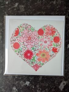 ruby floral heart painting on a greeting card
