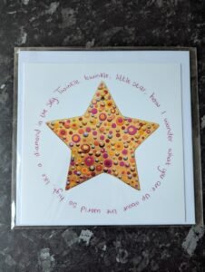 Gold star with drip painting technique inside. Twinkle twinkle lyrics surround