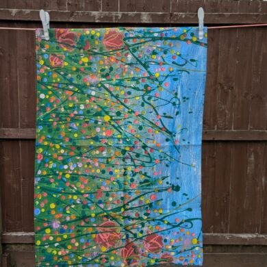floral tea towel hanging on the line for display