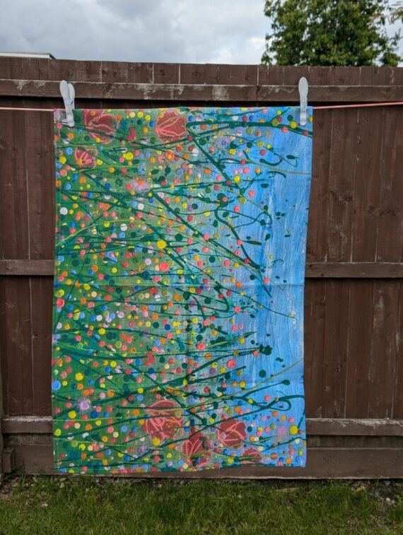 floral tea towel hanging on the line for display
