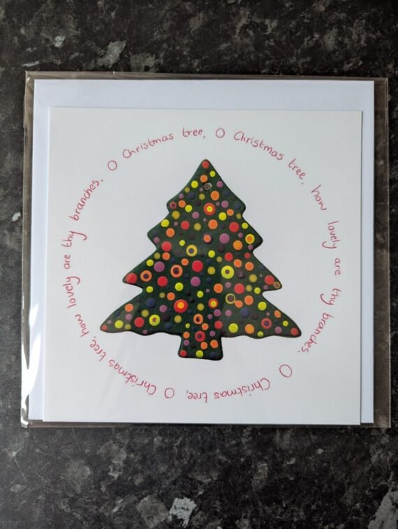 rainbow coloured paint droplets within a christmas tree shape. O christmas tree lyrics surround it in a circle